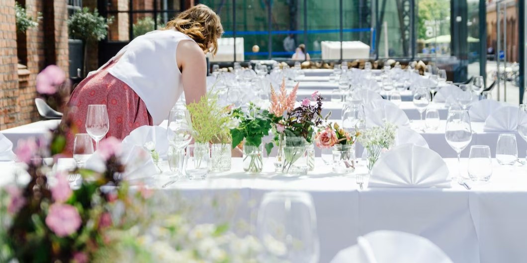 young woman decorating tables wedding ceremony event